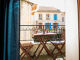 The balcony with a glimpse of the sea of the F2 apartment near the beach in the city center of Le Lavandou
